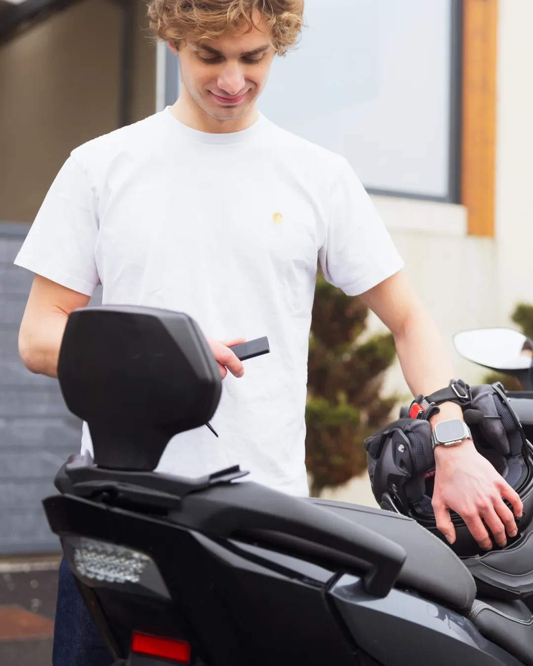 a man installing his GPS Pro Tracker in a scooter