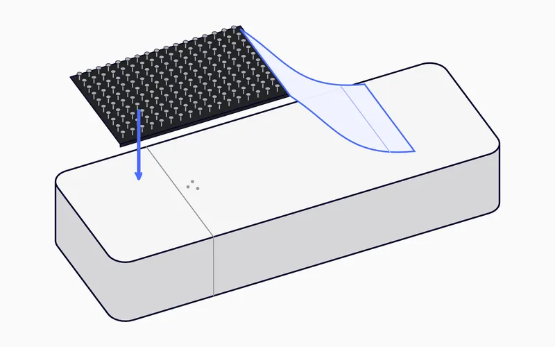 A Dual-Lock strip, with the protective film removed, applied to the back of the tracker