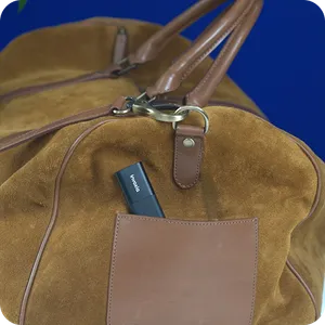 A Classic GPS Tracker slipped into a pocket of a carrying bag