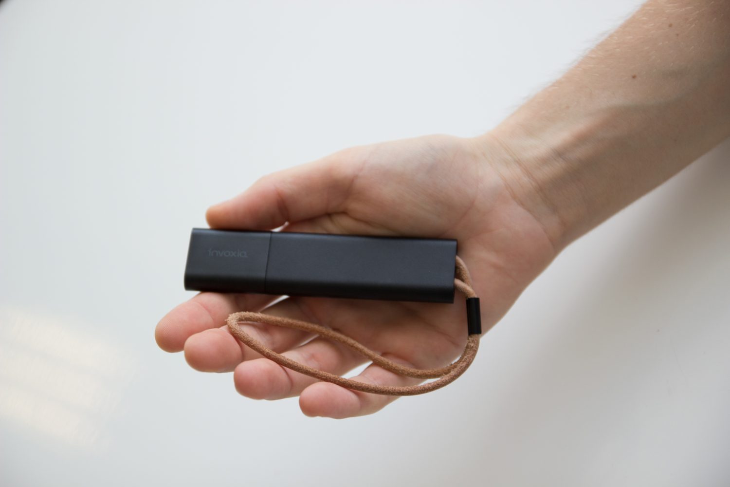 Image 2: a person with a small object in their hand