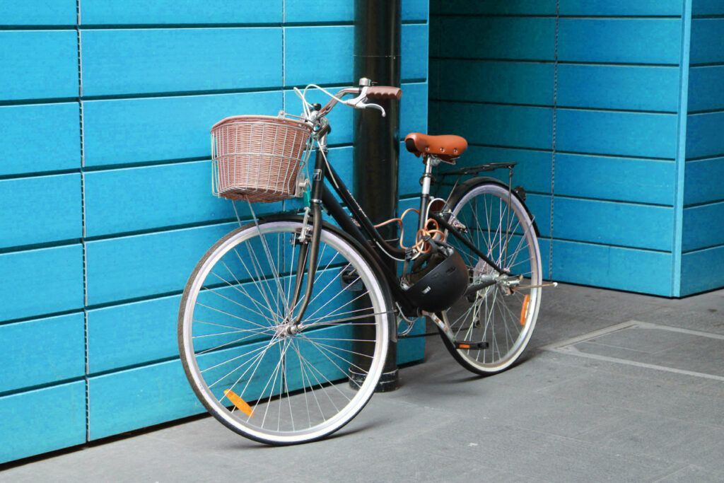 bike leaning against a blue wall