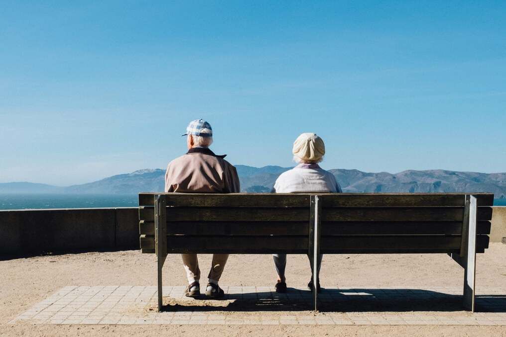senior couple sitting on a bench